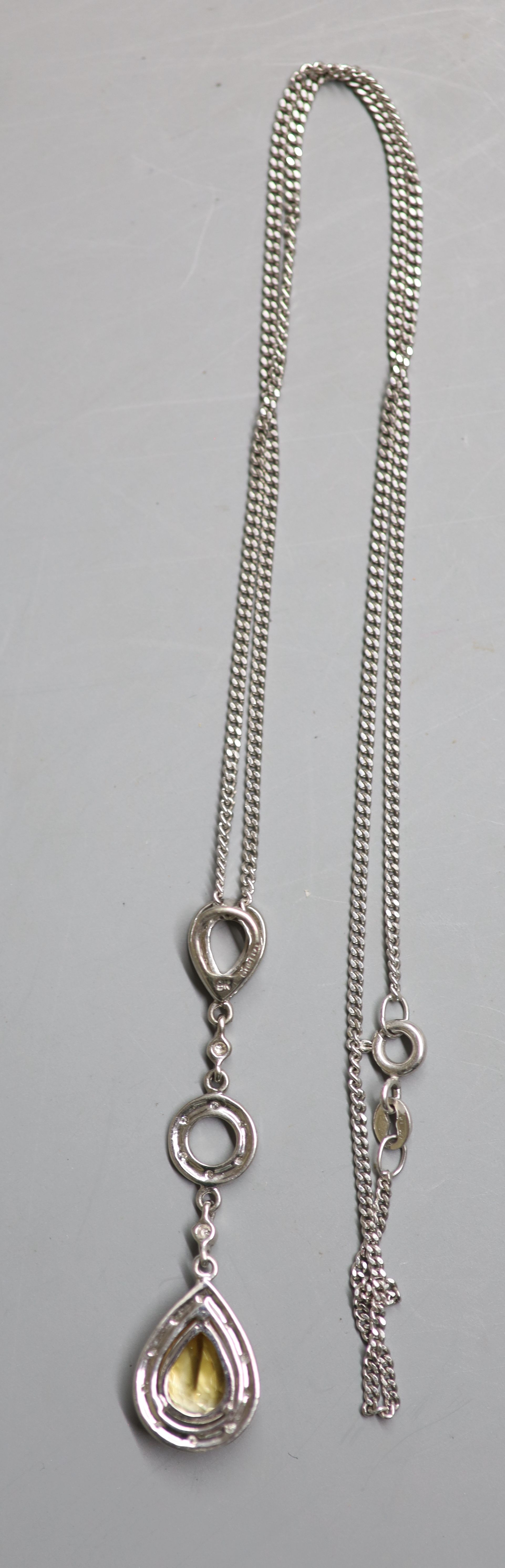 A modern 9ct white gold, pear shaped citrine and diamond cluster drop pendant, on a 9ct white gold chain,
